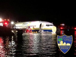 Boeing 737 slides off runway into Florida river