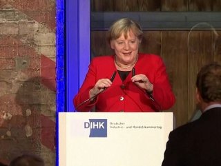 Merkel was almost falling as she trips over on stage
