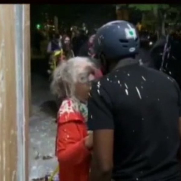Protesters throw paint at an elderly woman in Portland