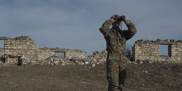 An Armenian soldier looks through binoculars. (Reuters photo)