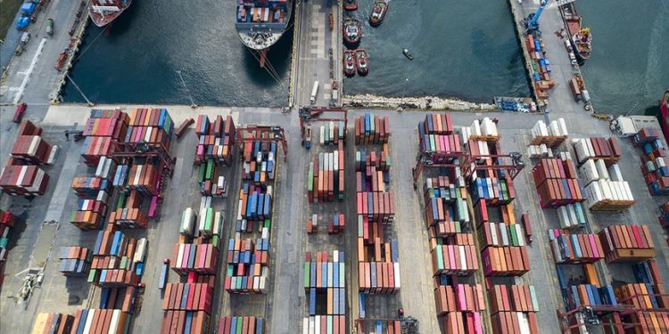An aerial view of a port where containers are alined.