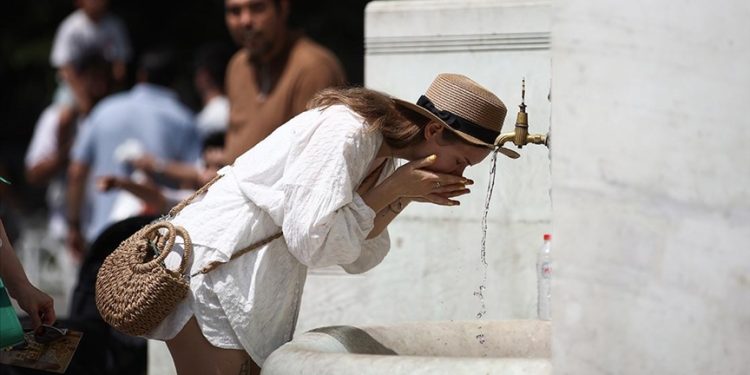 A woman washes her face after being exposed to high temperature.