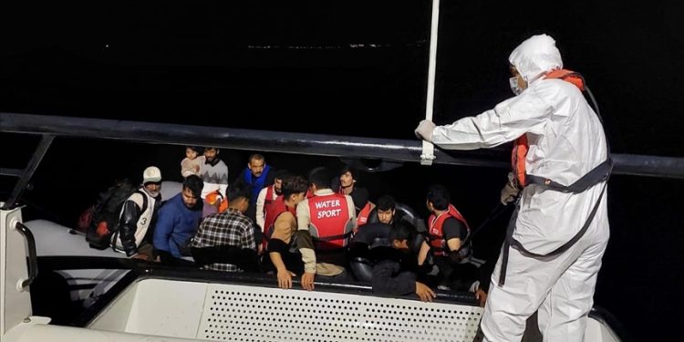 Irregular migrants are seen on a boat. (AA photo)