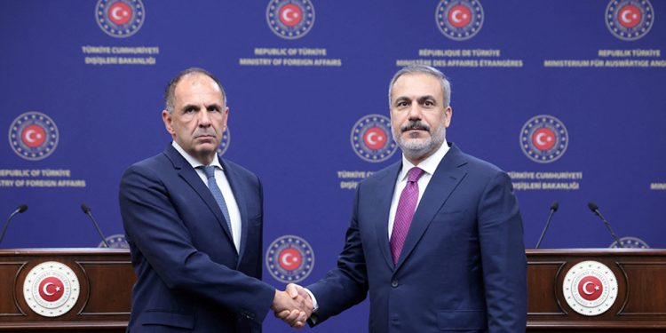 Turkish Foreign Minister Hakan Fidan shakes hand with his Greek counterpart George Gerapetritis in Ankara.